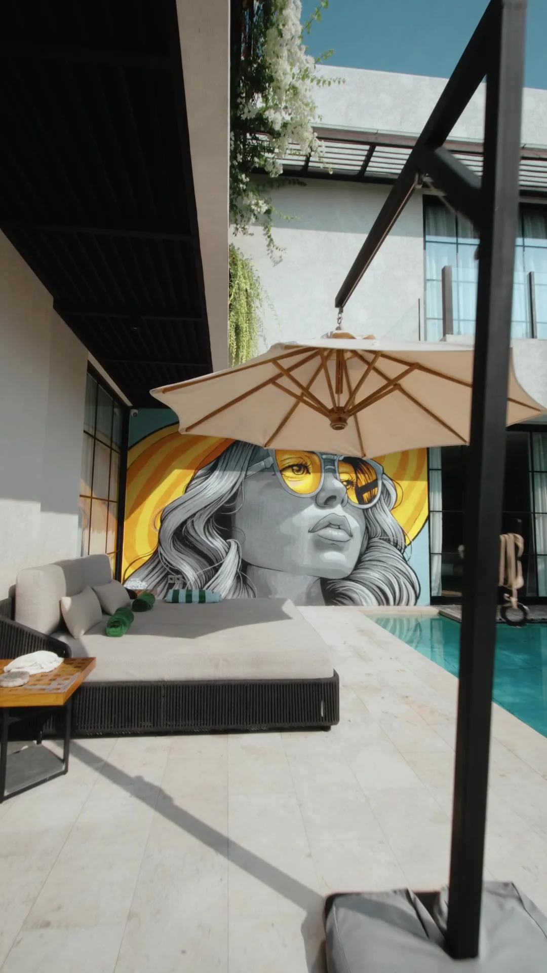 The villa’s pool and mural, a frame from the film