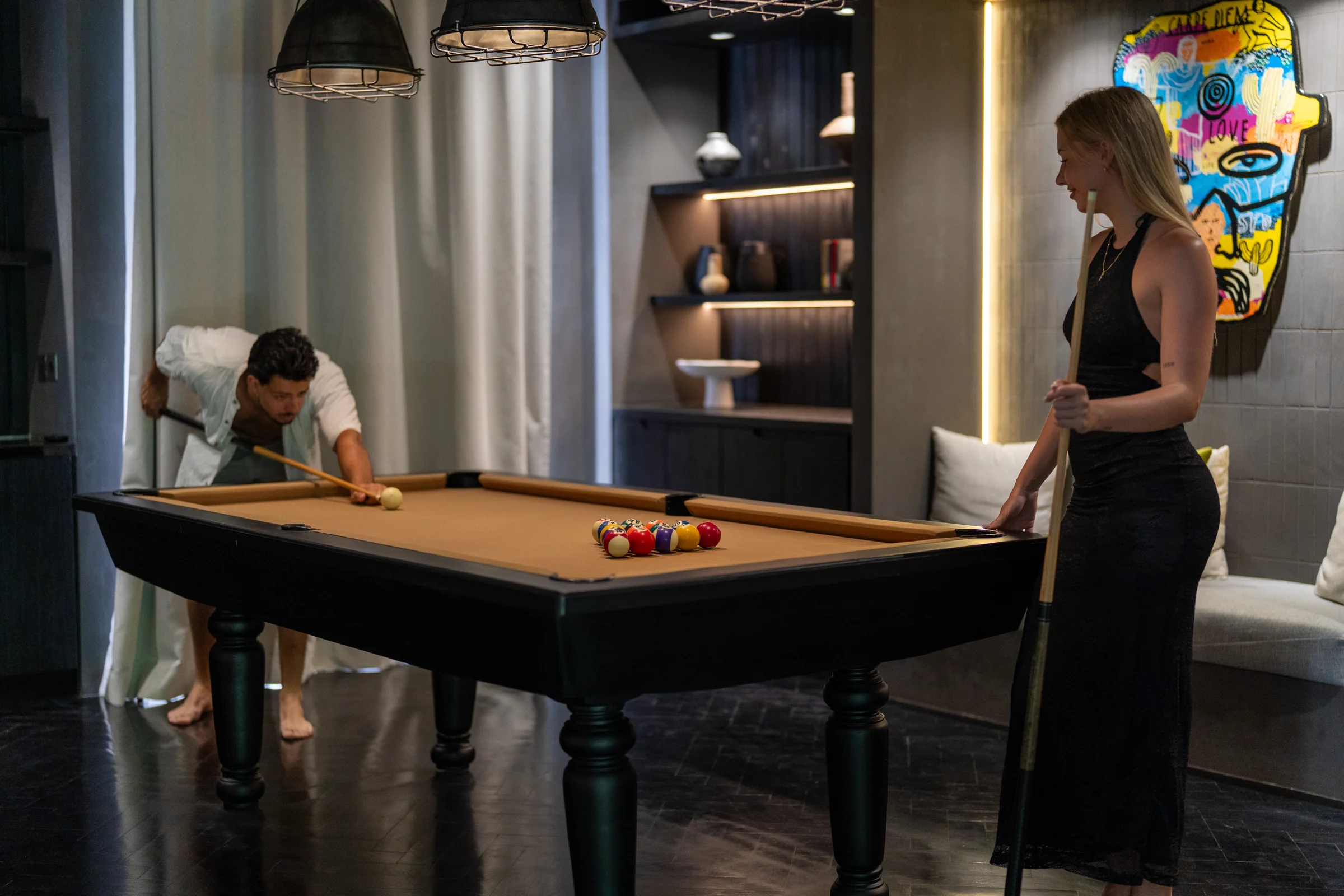 Two guests playing pool in CARPEDIEM’s games room