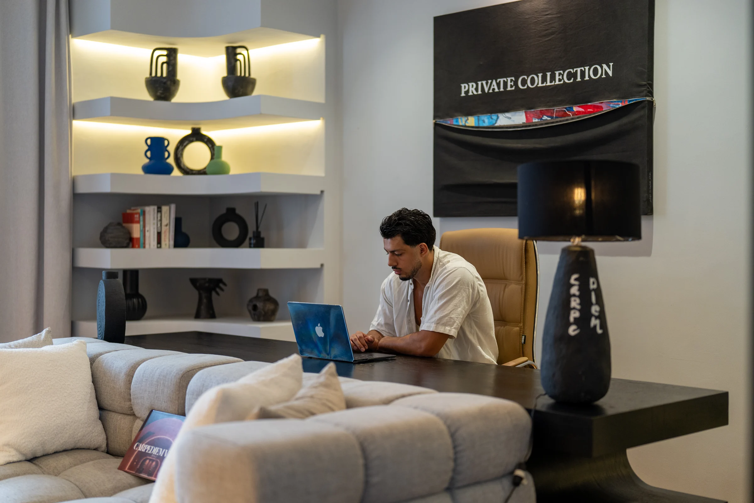 A guest using a laptop at the desk in CARPEDIEM’s private study
